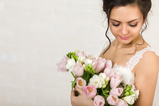 Portrait of beautiful bride with wedding bouquet