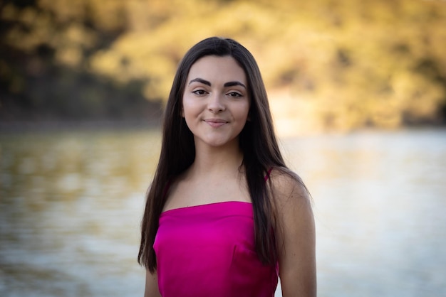 Portrait of a beautiful brunette girl wearing a pink top