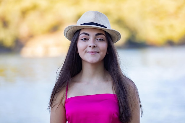 Portrait of a beautiful brunette girl wearing a pink top