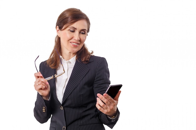 Portrait of a beautiful businesswoman 50 ears old with mobile phone isolated on white.