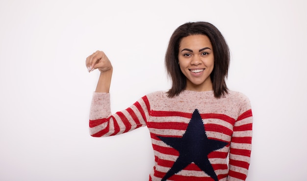 Portrait of beautiful calm young african american presenting by pointing hand on side.