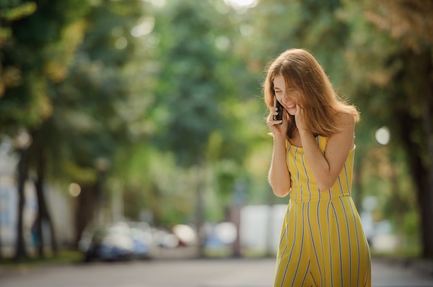 Portrait of beautiful cheerful redhead girl student.