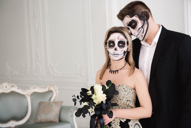 Portrait of a beautiful couple in medieval costumes with vampire style make-up