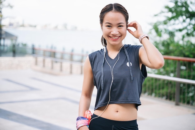 Portrait beautiful exercise girl touch earphones