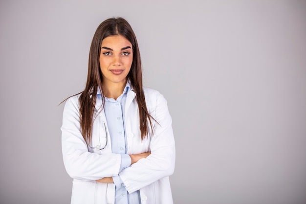 Portrait of beautiful female doctor looking at camera.Beautiful female doctor. Woman doctor dressed white medical uniform isolated studio portrait.