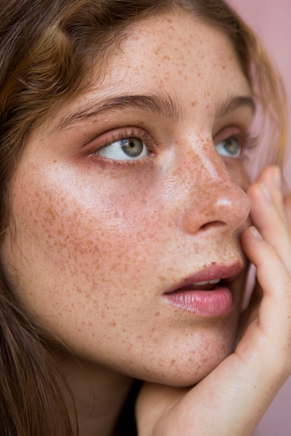 Portrait of beautiful freckled woman looking away