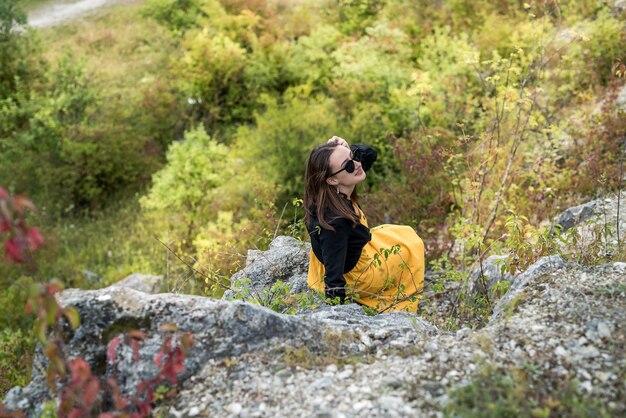 Portrait of beautiful girl on the background of rocks travel and holiday concept