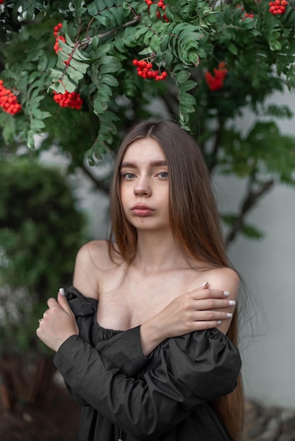 portrait of a beautiful girl on the background of a tree with flowers