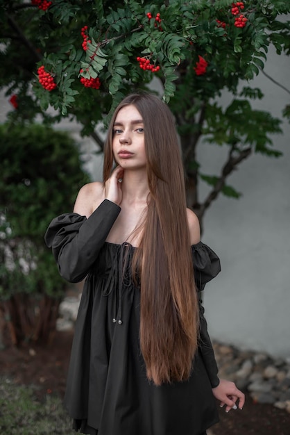 portrait of a beautiful girl on the background of a tree with flowers