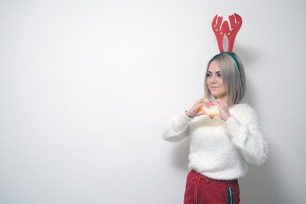 Portrait of a beautiful girl on a light background The concept of Christmas and New Year