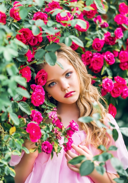 Portrait of a beautiful girl in rose flowers