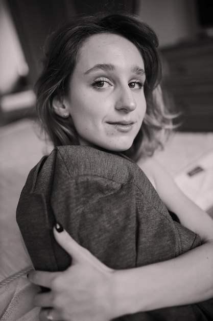 Portrait of a beautiful girl in sexy black lingerie with curly brown hair black and white photo