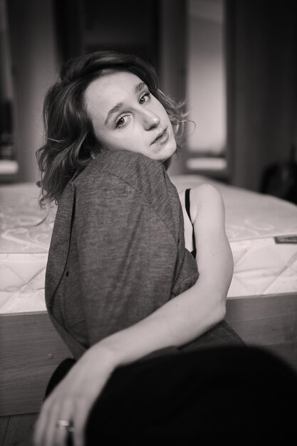 Portrait of a beautiful girl in sexy black lingerie with curly brown hair black and white photo