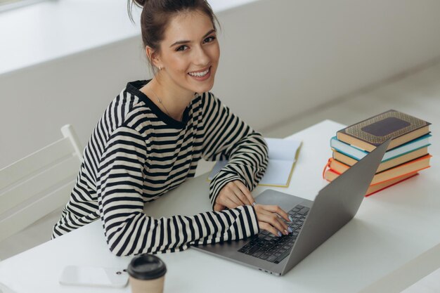 Portrait of a beautiful girl studying at home