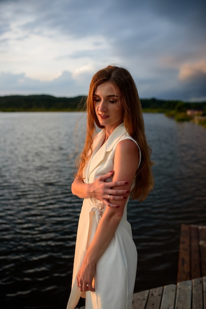 Portrait of a beautiful girl during sunset before a thunderstorm.