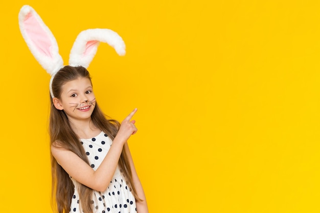 Portrait of a beautiful girl with big ears of an Easter bunny on her head the onset of the Easter holiday