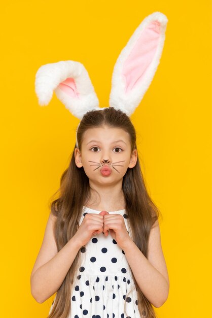 Portrait of a beautiful girl with big ears of an Easter bunny on her head the onset of the Easter holiday