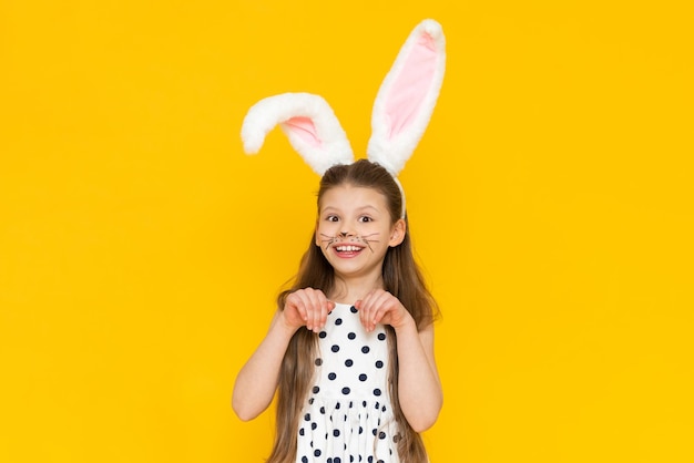 Portrait of a beautiful girl with big ears of an Easter bunny on her head the onset of the Easter holiday