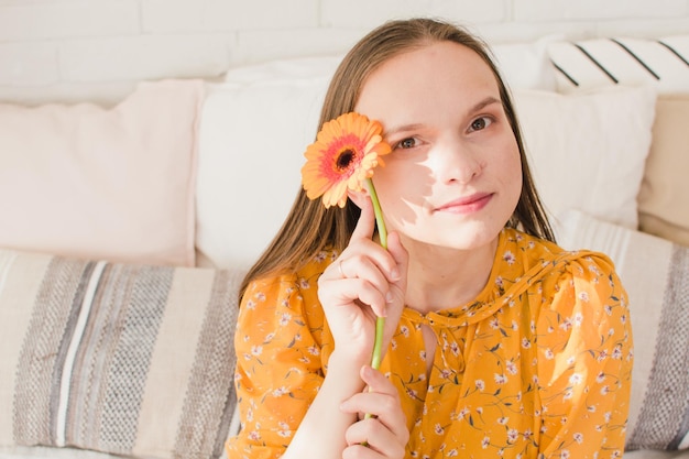 Portrait of a beautiful girl with a flower in her hands