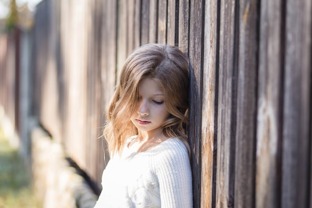 portrait of a beautiful girl with long hair on nature in summer