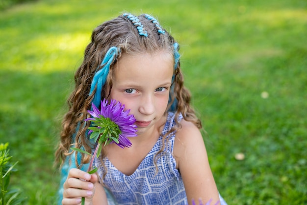 Portrait of beautiful girl with many braids with blue kanekalon