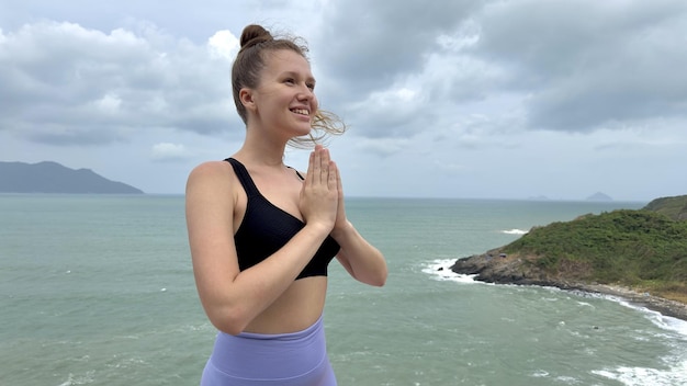 Portrait of beautiful girl young happy carefree relaxed woman at sea ocean background enjoying summer sunny day vacation on mountain smiling in tropical country practice yoga meditating