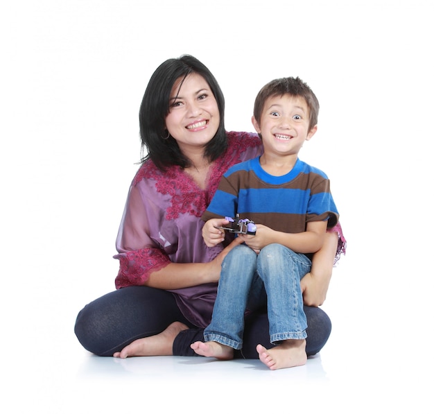 Portrait of a beautiful happy mother with smiling boy isolated on white