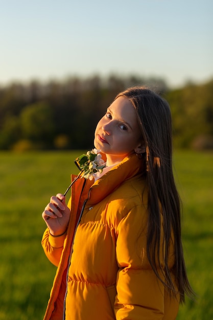 Portrait of a beautiful happy teenage girl outdoors in spring