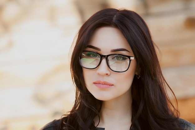 portrait of a beautiful hipster girl in glasses Concept beautiful eyes beautiful smile vision