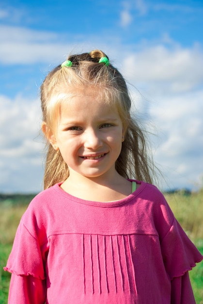 Portrait of beautiful little girl in a meadow