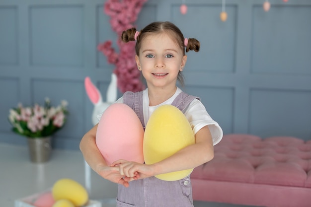 portrait beautiful little girl playing with easter eggs girl holding ostrich eggs little farmer