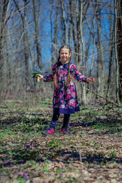 Portrait of a beautiful little girl with corydalis flowers