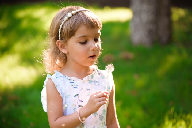 Portrait of a beautiful little girl with heterochromia two colored eyes with flowers