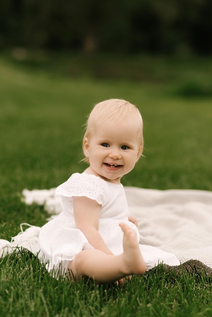 Portrait of a beautiful little happy girl in nature picnic family