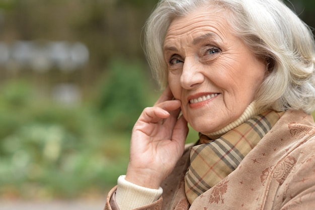 Portrait of a beautiful middle-aged woman in autumn park