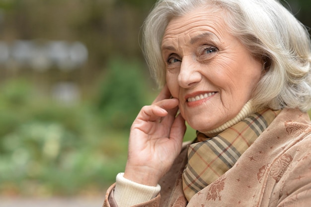 Portrait of a beautiful middle-aged woman in autumn park