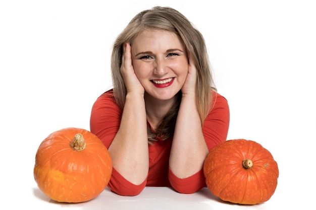 Portrait of beautiful middleaged blonde woman with pumpkin ready for halloween celebration mockup for postcard and invitation or advertisement