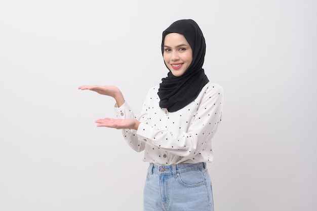 Portrait of beautiful muslim woman with hijab over white background studio