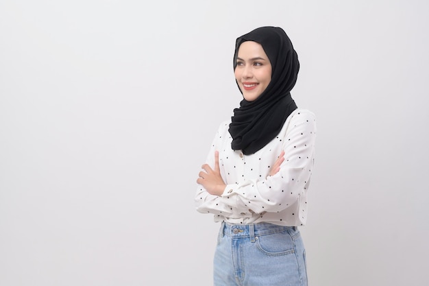 Portrait of beautiful muslim woman with hijab over white background studio