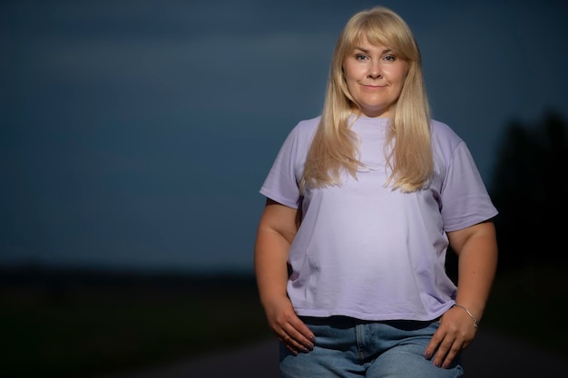 Portrait of a beautiful plump middleaged woman outdoors