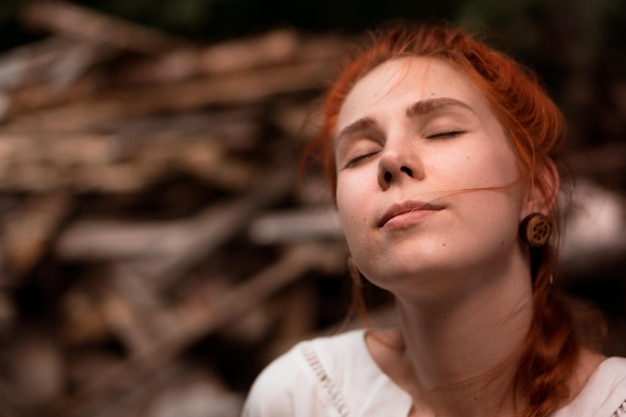 portrait of beautiful redhead woman outdoors in summer