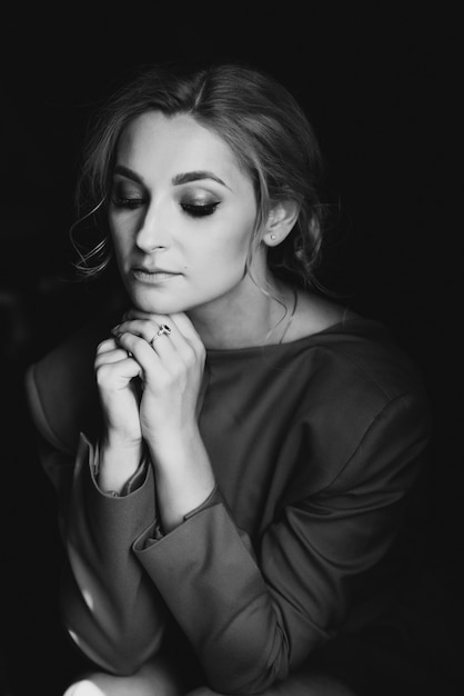 Portrait of beautiful romantic girl lady in red dress in room in the loft style.  Beauty, fashion. 