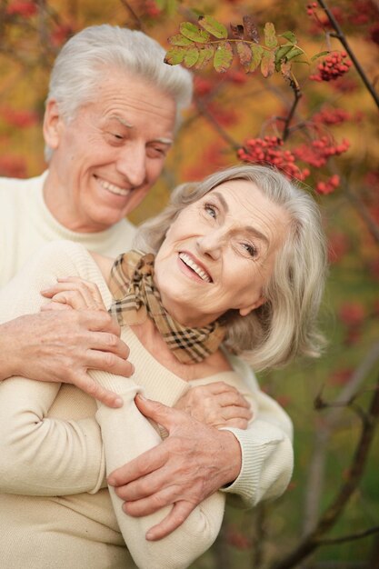 Portrait of beautiful senior couple in autumn park