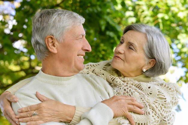 Portrait of beautiful senior couple in autumn park