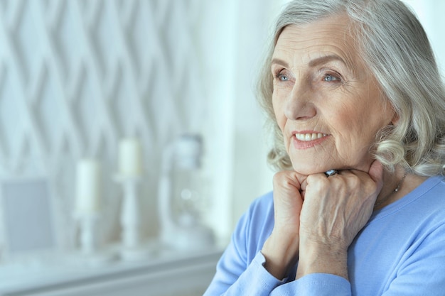 Portrait of beautiful senior woman posing at home