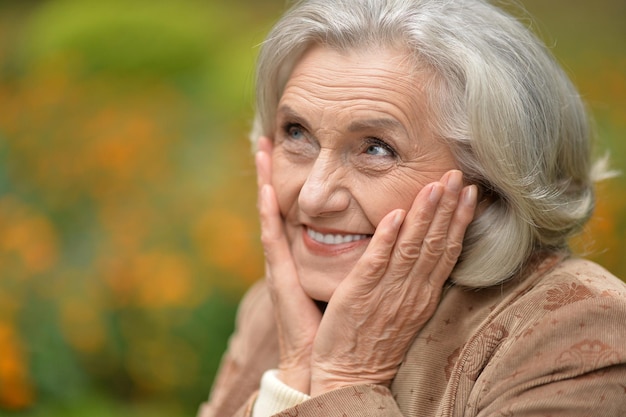 Portrait of beautiful senior woman posing in park