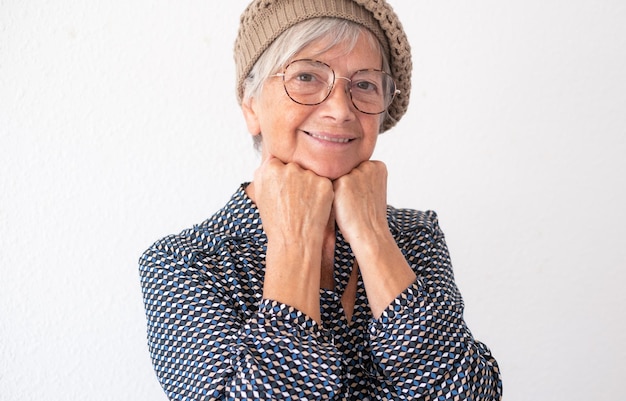 Portrait of beautiful senior woman wearing glasses looking at camera smiling Short haired caucasian lady in modern shirt feeling in a good mood