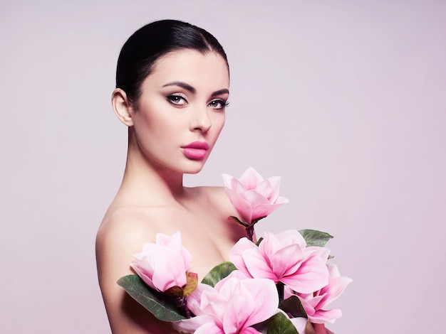 Portrait of a beautiful sensual woman with flowers