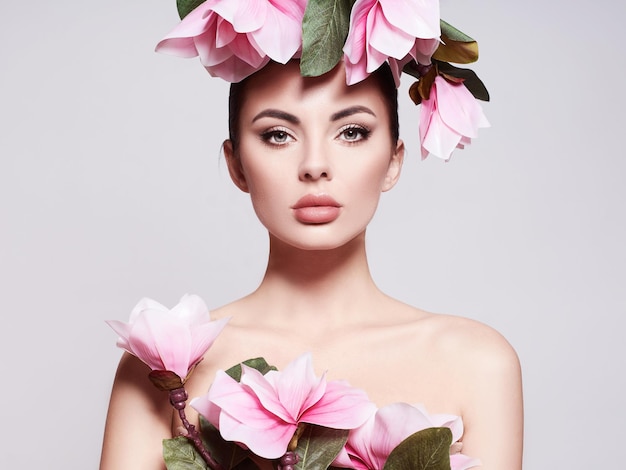 Portrait of a beautiful sensual woman with flowers