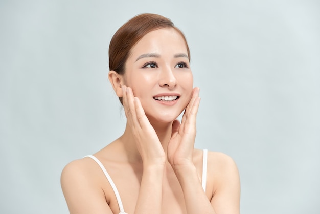 Portrait of Beautiful Skin care woman enjoy and happy, touching her face